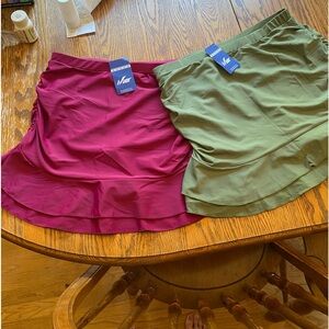 Two women’s swim skirts, one cranberry one green